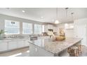 Bright kitchen featuring white cabinets, stainless steel appliances, granite counters, and a large center island at 378 Glacier Way, Conway, SC 29526