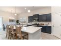 Modern kitchen with dark blue cabinetry, white quartz countertops, and stainless steel appliances at 386 Glacier Way, Conway, SC 29526