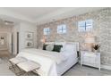 Spacious main bedroom with a leafy patterned wall, king-size bed, and plenty of natural light at 386 Glacier Way, Conway, SC 29526