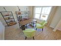 Home office with wood desk, green chairs, and built-in shelving at 511 Firouz Dr, Longs, SC 29568