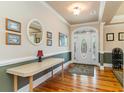 Welcoming foyer with hardwood floors, decorative rug, and a beautiful front door at 512 Goff Creek Ct., Myrtle Beach, SC 29579
