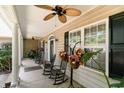 Inviting front porch with rocking chairs, plants, and ceiling fans at 512 Goff Creek Ct., Myrtle Beach, SC 29579