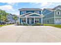 Two-story blue house with white trim, porch, and driveway at 5907 Haskell Circle, Myrtle Beach, SC 29572