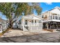 Quaint white cottage with a front porch and walkway at 6001-1235 S Kings Highway, Myrtle Beach, SC 29575