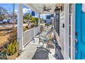 Inviting front porch offers white wicker rocking chairs and charming decor, perfect for relaxing at 637 Sparrow Dr., Surfside Beach, SC 29575