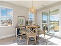Bright dining area with a round table, four chairs, and access to a screened porch at 7027 Shooting Star Way, Myrtle Beach, SC 29579