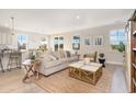 Spacious living room featuring a beige couch, coffee table, and ample natural light at 7027 Shooting Star Way, Myrtle Beach, SC 29579