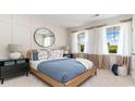 Light and airy bedroom with a blue bed and large windows at 7093 Shooting Star Way, Myrtle Beach, SC 29579