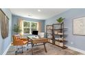 Home office with a wooden desk, shelving and comfortable chair at 7093 Shooting Star Way, Myrtle Beach, SC 29579