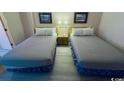 Two double beds in a condo bedroom with light wood flooring at 7500 N Ocean Blvd. # 6145, Myrtle Beach, SC 29572