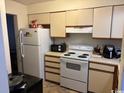 Small kitchen with white appliances and light wood cabinets at 1025 Carolina Rd. # Ee-3, Conway, SC 29526