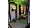 Inviting front porch with yellow chairs and decorative wreath at 106 Fonza St., Conway, SC 29526
