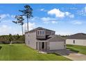 Two-story house with gray siding, white garage door, and green lawn at 161 Saddle St, Conway, SC 29527