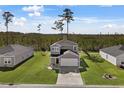 Two-story house with gray siding, two-car garage, and a spacious backyard at 161 Saddle St, Conway, SC 29527