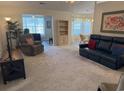 Spacious living room featuring plush carpeting, neutral tones, and an open layout perfect for entertaining or relaxation at 179 Wiltshire Ct., Longs, SC 29568
