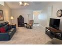 Inviting living room featuring plush carpeting, neutral tones, and an open layout perfect for entertaining or relaxation at 179 Wiltshire Ct., Longs, SC 29568