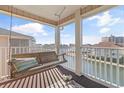 Covered porch has a porch swing facing out to the waterway at 1900 Duffy St. # C-7, North Myrtle Beach, SC 29582