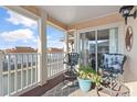 A balcony featuring chairs, a table, and views of the waterway at 1900 Duffy St. # C-7, North Myrtle Beach, SC 29582
