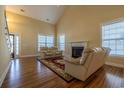 Bright living room with a fireplace, hardwood floors, and large windows at 217 Appian Way, Myrtle Beach, SC 29588