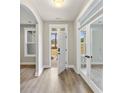 Inviting hallway with neutral paint, luxury vinyl plank floors and glass paneled doors at 217 Wahee Pl., Conway, SC 29527