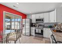 Modern kitchen with white cabinets, stainless steel appliances, and granite countertops at 3102 Regency Oak Dr., Myrtle Beach, SC 29579