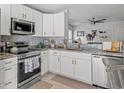 Modern kitchen with white cabinets, stainless steel appliances, and granite countertops at 3102 Regency Oak Dr., Myrtle Beach, SC 29579