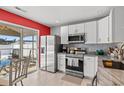 Modern kitchen with white cabinets, stainless steel appliances, and granite countertops at 3102 Regency Oak Dr., Myrtle Beach, SC 29579
