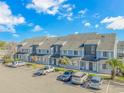 Aerial view of townhouses with parking and surrounding landscape at 3700 Golf Colony Lane # 20-L, Little River, SC 29566