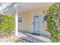 Inviting building entrance with a white door and well-maintained landscaping at 4281 Hibiscus Dr. # 2-102, Little River, SC 29566