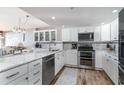 Modern white kitchen with granite countertops and stainless steel appliances at 501 S Ocean Blvd. # 304, North Myrtle Beach, SC 29582