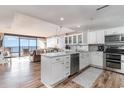 Modern white kitchen with stainless steel appliances and ocean view at 501 S Ocean Blvd. # 304, North Myrtle Beach, SC 29582