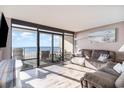 Living room with ocean view and comfortable seating at 501 S Ocean Blvd. # 304, North Myrtle Beach, SC 29582