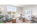 Bright living room featuring a comfy sofa, armchair, and large window at 538 Firouz Dr, Longs, SC 29568