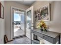Bright and airy entryway with a console table and framed artwork at 575 Mossbank Loop, Longs, SC 29568