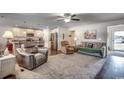 Open living space with hardwood floors and access to the kitchen at 575 Mossbank Loop, Longs, SC 29568