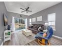 Bright living room featuring hardwood floors, comfortable seating, and large windows at 612 River Oaks Dr. # 55-C, Myrtle Beach, SC 29579
