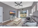 Relaxing living room with hardwood floors, comfortable sofa, and sliding glass doors at 612 River Oaks Dr. # 55-C, Myrtle Beach, SC 29579