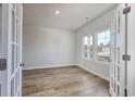 Bright home office with wood-look floors and French doors at 616 St. Albans Loop, Conway, SC 29526