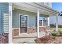 Inviting front porch with brick accents and ample natural light streaming through the windows at 808 St. Albans Loop, Conway, SC 29526