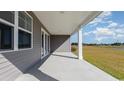 Covered patio with view of grassy area and pond at 822 Ireland Dr., Longs, SC 29568