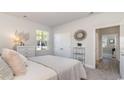 Spacious main bedroom with a window overlooking the backyard and en-suite bathroom at 826 Ireland Dr., Longs, SC 29568