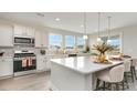 Modern kitchen with white cabinets, large island, and stainless steel appliances at 834 Ireland Dr., Longs, SC 29568