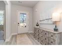 Bright entryway with wood-look floors and decorative console table at 842 Ireland Dr., Longs, SC 29568