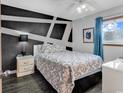 Bedroom featuring a modern accent wall, plush bedding, and a bright window view at 1012 N Waccamaw Dr. # 203, Murrells Inlet, SC 29576