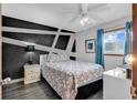 Bedroom featuring a modern accent wall, plush bedding, and a bright window view at 1012 N Waccamaw Dr. # 203, Murrells Inlet, SC 29576