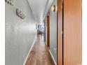 Hallway showcasing hardwood floors, neutral wall color, and easy access to multiple rooms at 1012 N Waccamaw Dr. # 203, Murrells Inlet, SC 29576