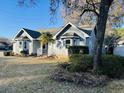 Gray house with palm tree and manicured shrubs at 104 Willow Ridge Rd., Myrtle Beach, SC 29588