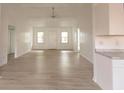 Bright living room with light wood flooring, white walls, a ceiling fan, and natural light at 104 Willow Ridge Rd., Myrtle Beach, SC 29588