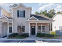 Two-story townhome with neutral siding and landscaping at 107 Maddux Ln. # E, Myrtle Beach, SC 29588