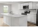 Modern kitchen featuring an island, stainless steel appliances, and white cabinets at 1080 Oak Meadow Dr., Conway, SC 29526